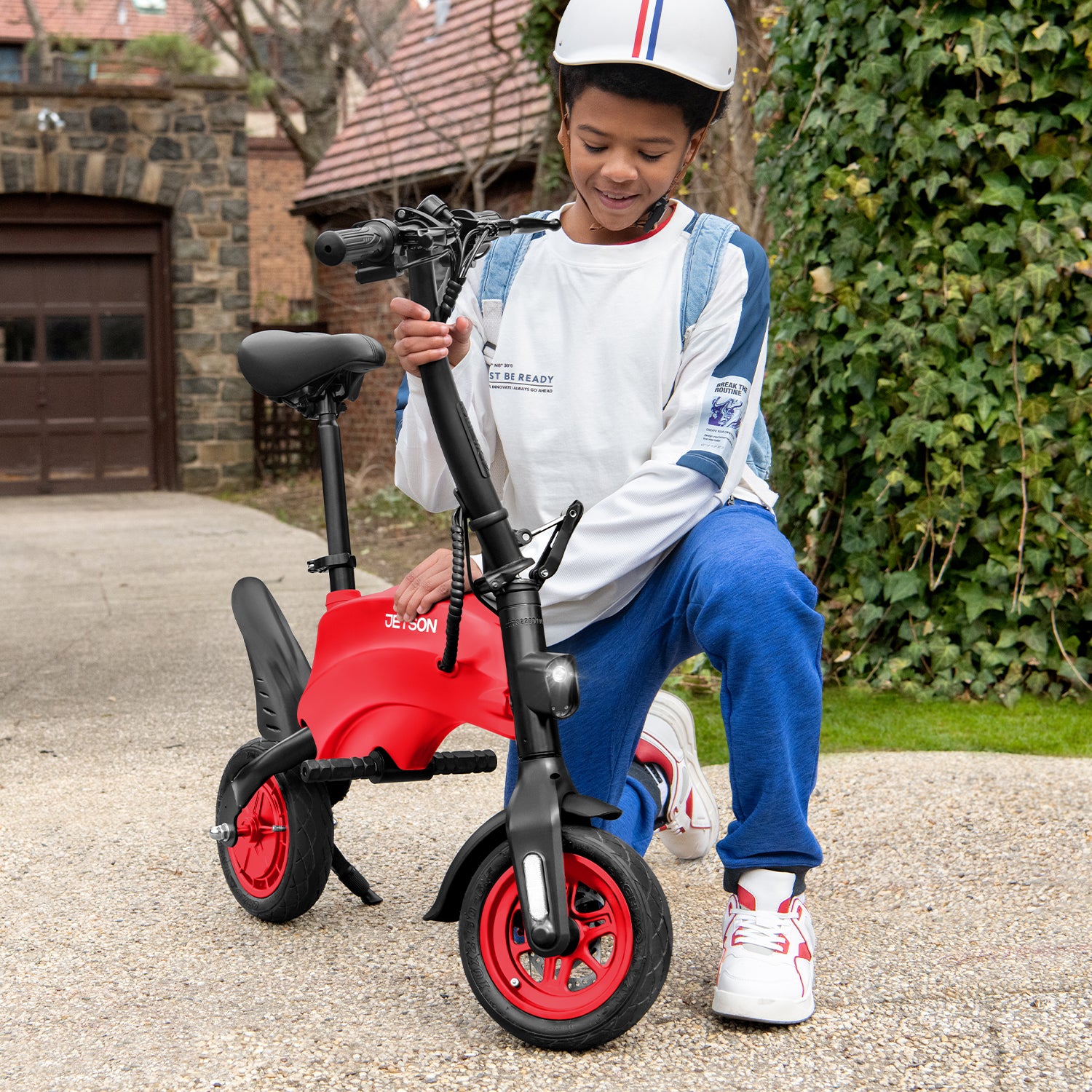 person kneeling down either unfolding or folding their red LX10