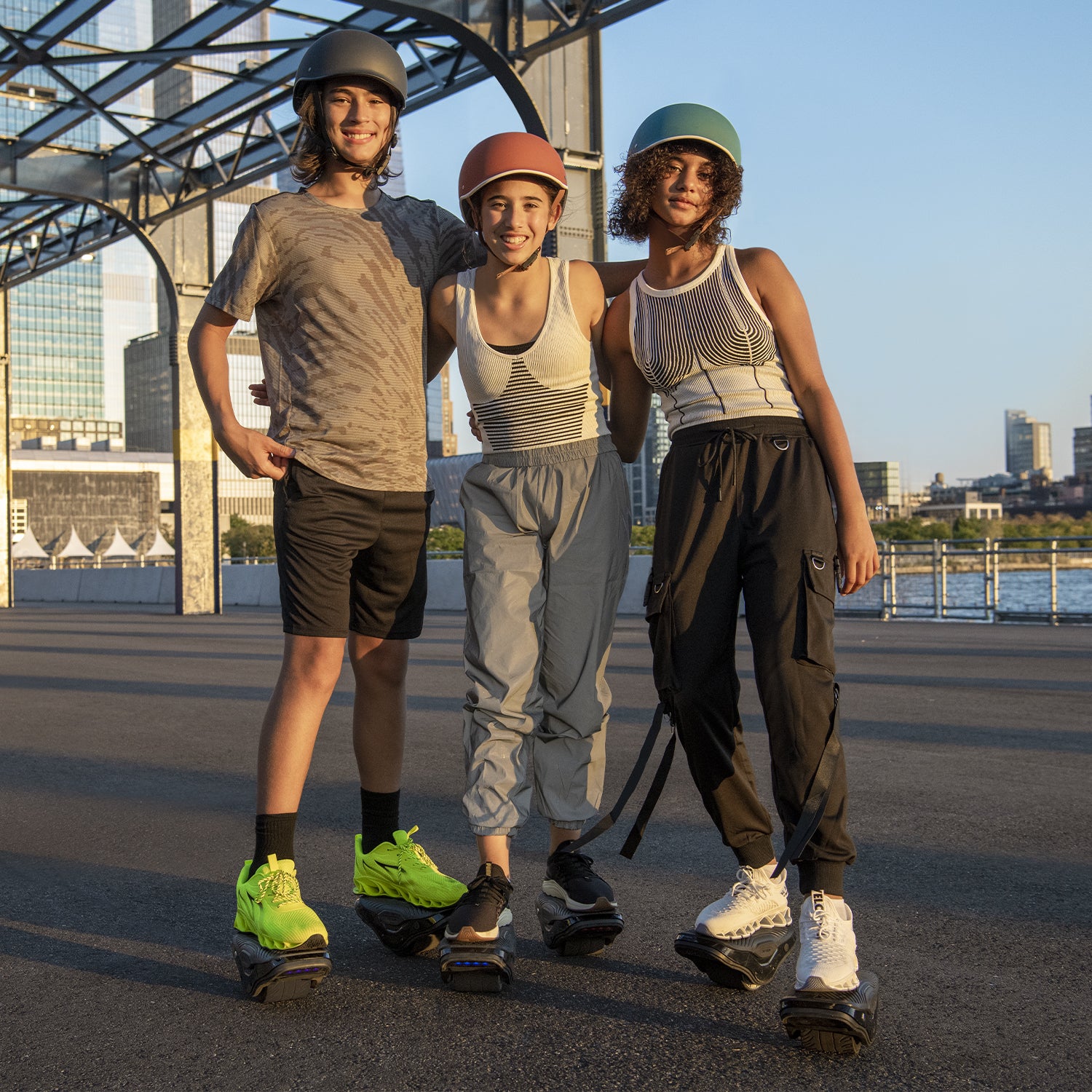 three young people standing together on their MotoKicks