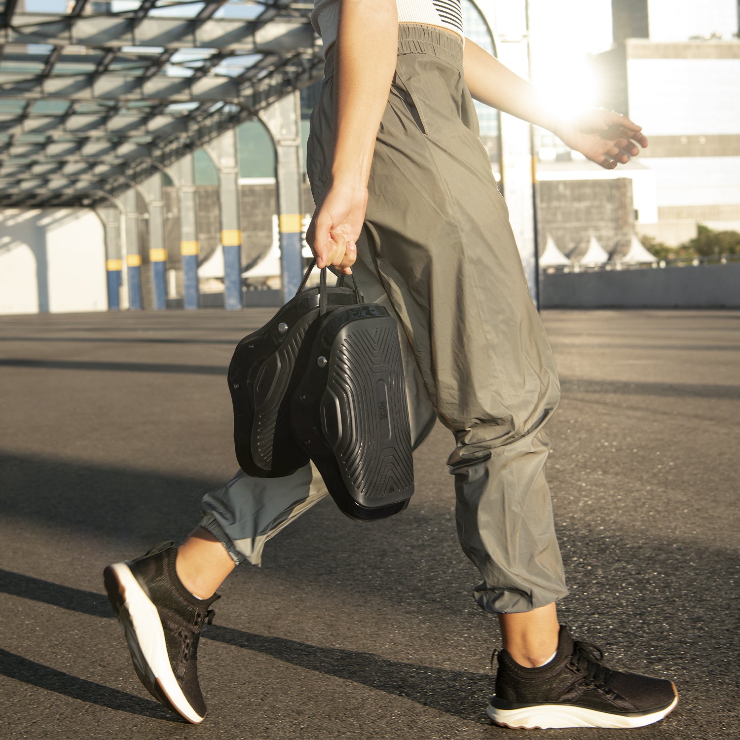 person walking on a road holding their MotoKicks