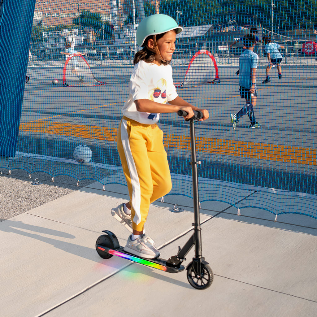 girl having fun at the park riding on e-scooter 