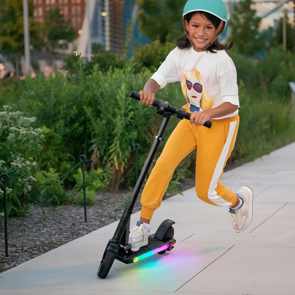 girl smiling on e-scooter and actively riding