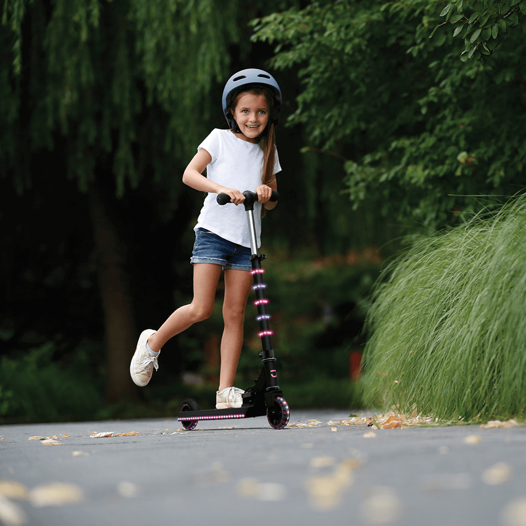 girl in a helmet riding the pink and purple orbit kick scooter