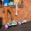 two people hanging out next to their Plasma X hoverboards