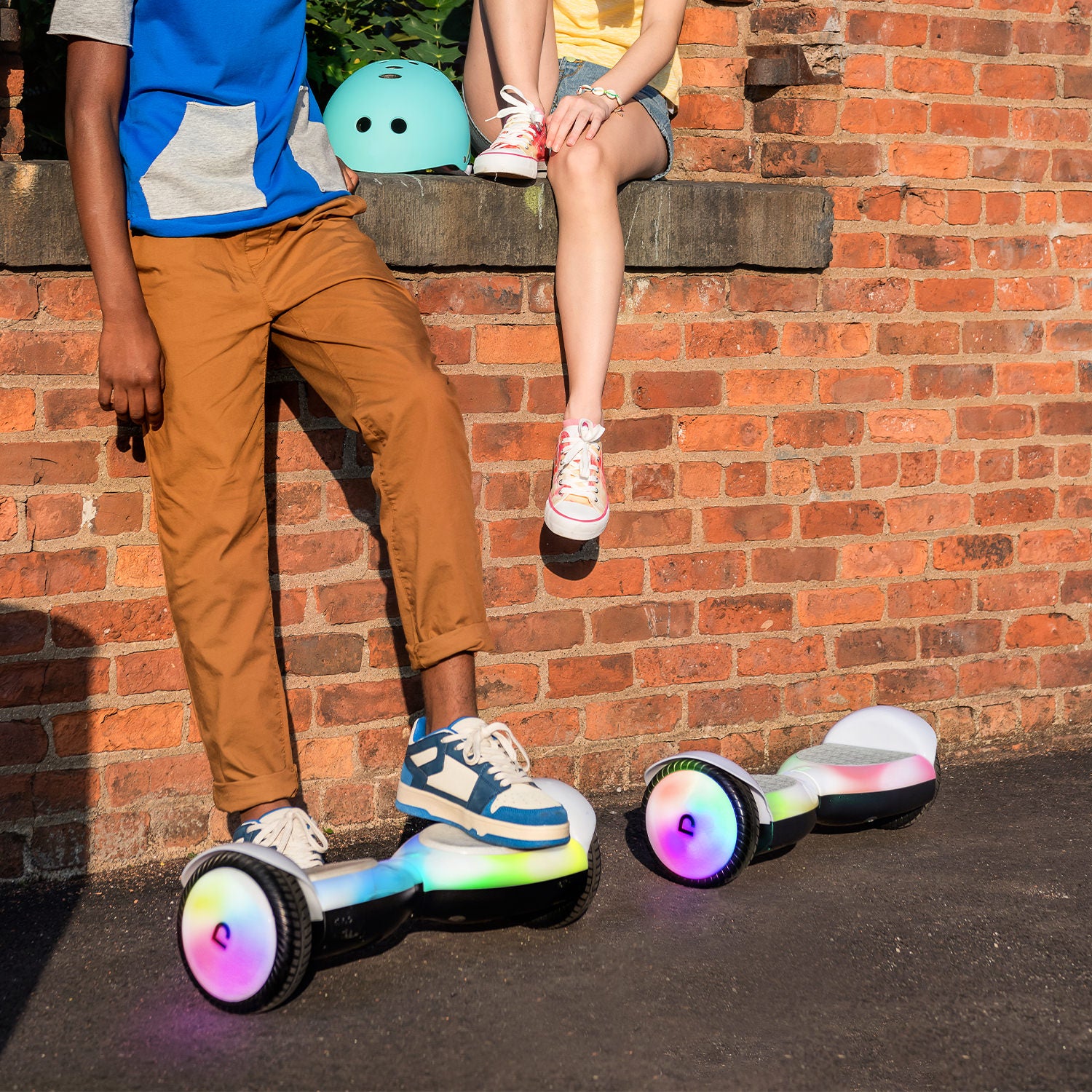 two people hanging out next to their Plasma X hoverboards