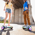 two people riding their Plasma X hoverboards under a bridge next to the river