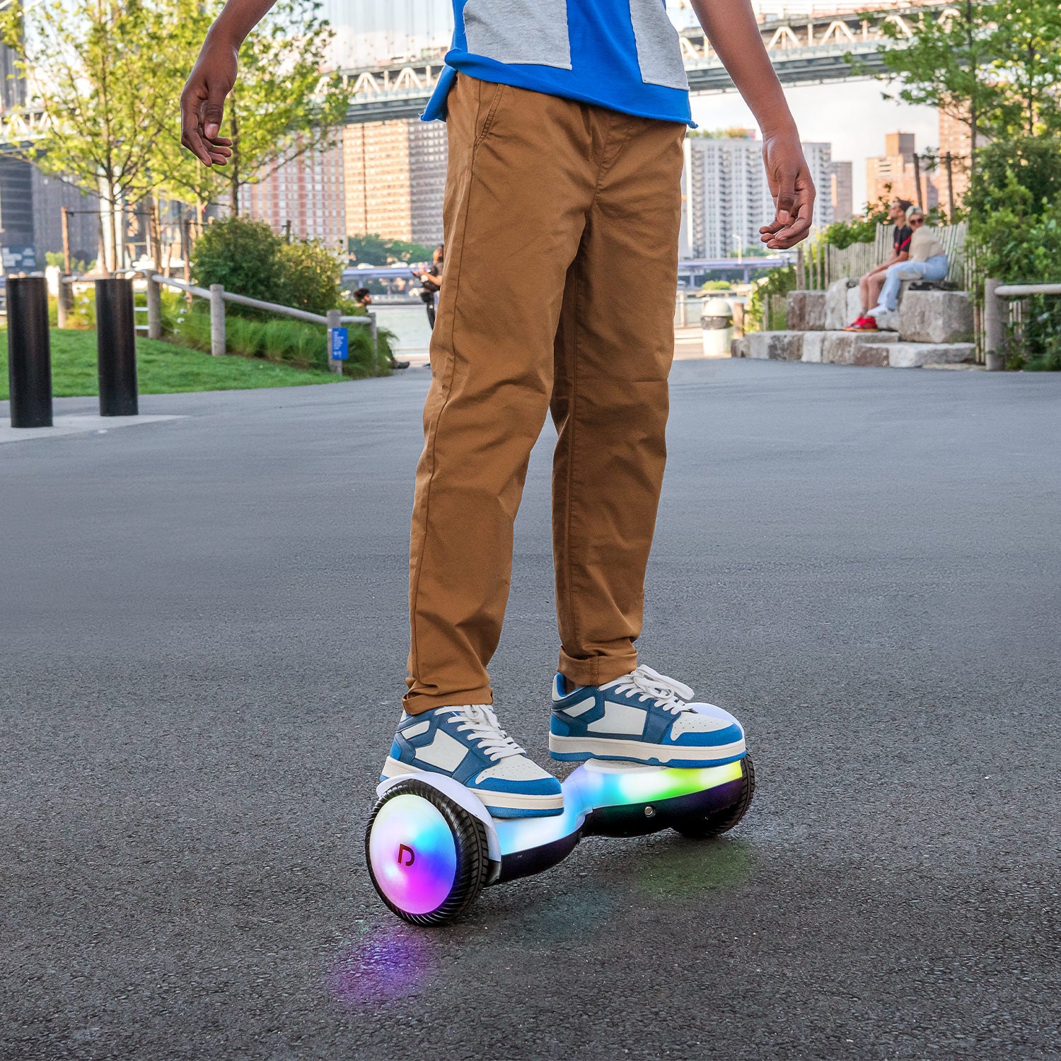 close up of person riding the Plasma X hoverboard in a park next to the river