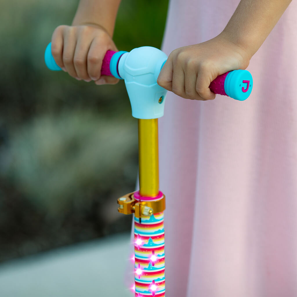 close up of a kid's hands on the scooter handlebar