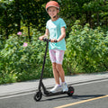 kid riding relay scooter on the road