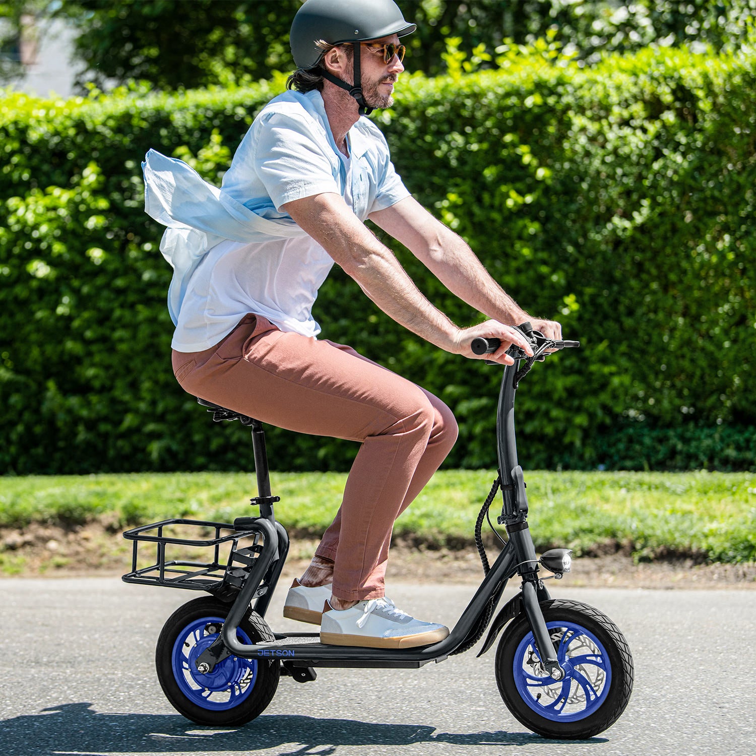 side view of person riding the Ryder electric scooter