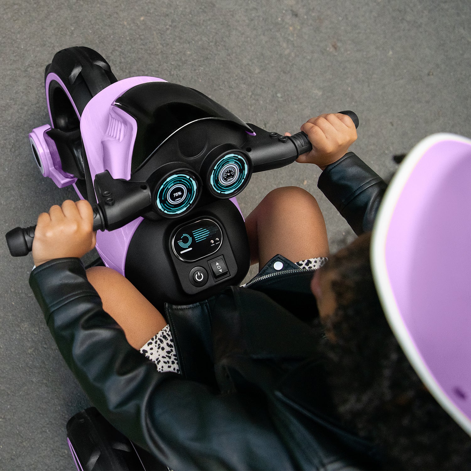top view of the controls and of a child riding the Trooper with their hands on the handlebars 